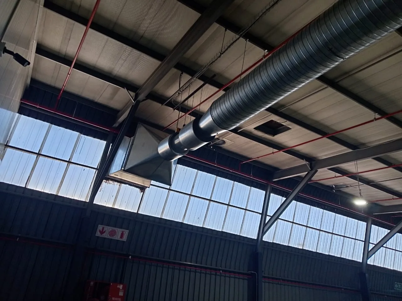 Large commercial extraction duct running through a facility