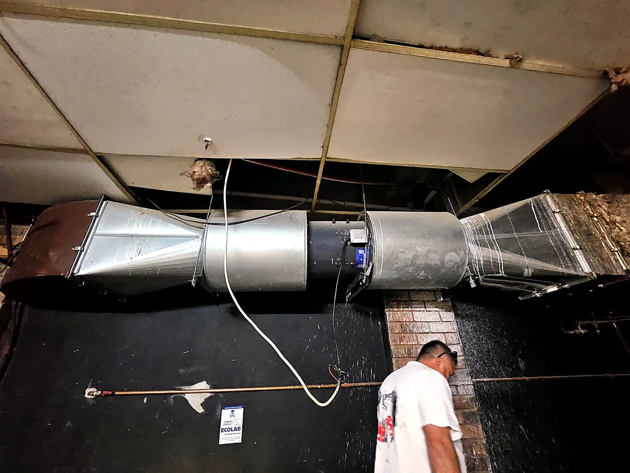 Technician inspecting commercial ductwork